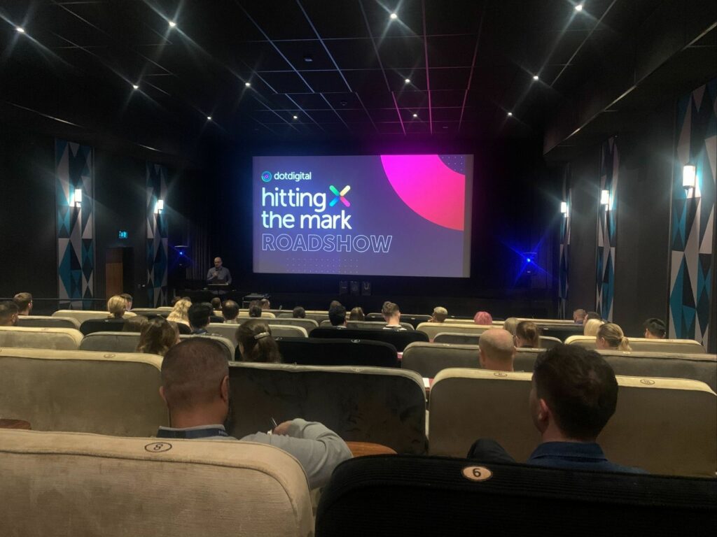 Delegates sit in cinema seating to watch our presentation