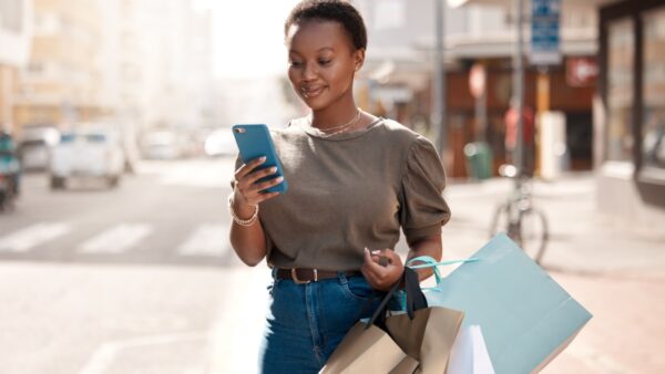 Happy shopper viewing their inbox of promotional emails.