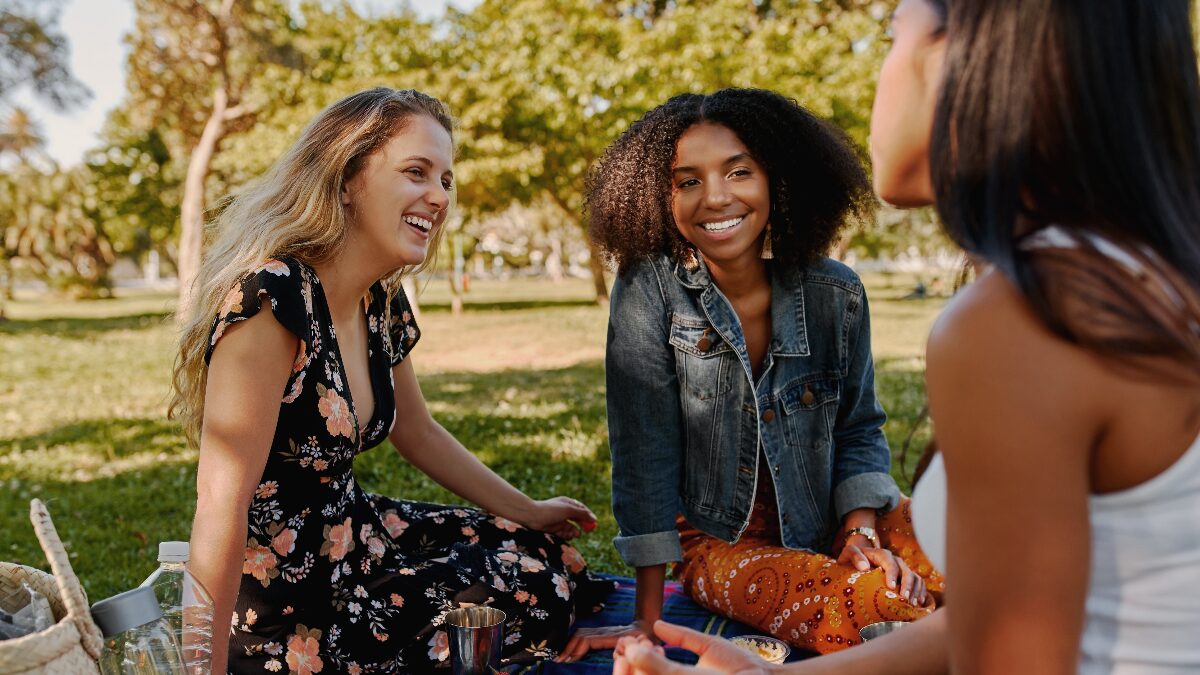 Friends sitting outside celebrating International Day of Friendship.