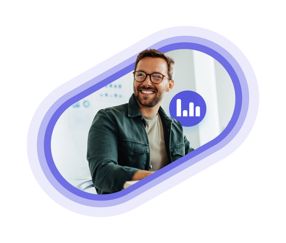 A person in a green jacket smiling in an office space