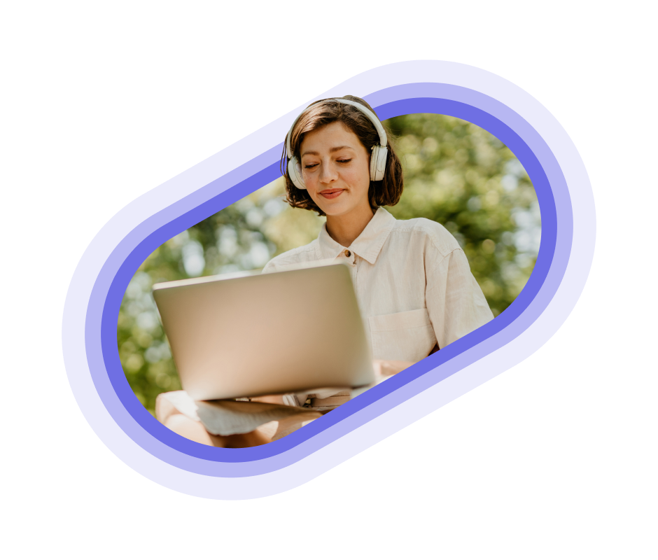 A person with headphones using their laptop