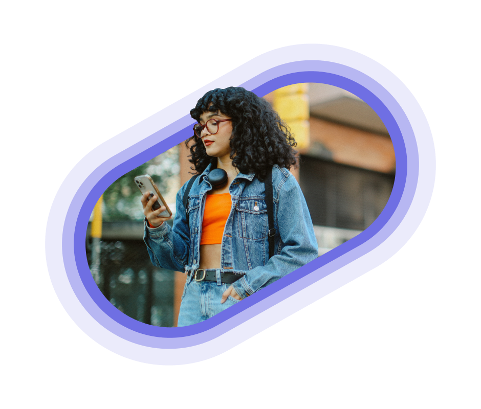A person in a denim jacket using their phone