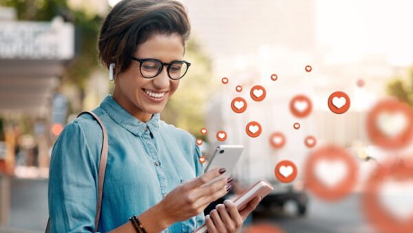 Happy woman sending love icons online