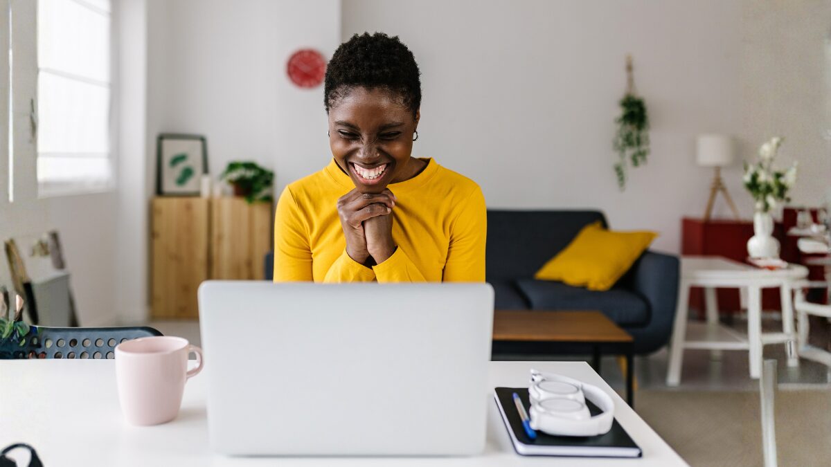 Happy woman at her laptop exploring new Dotdigital email marketing tools