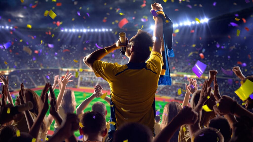 A fan celebrating in a vibrant stadium stock photo