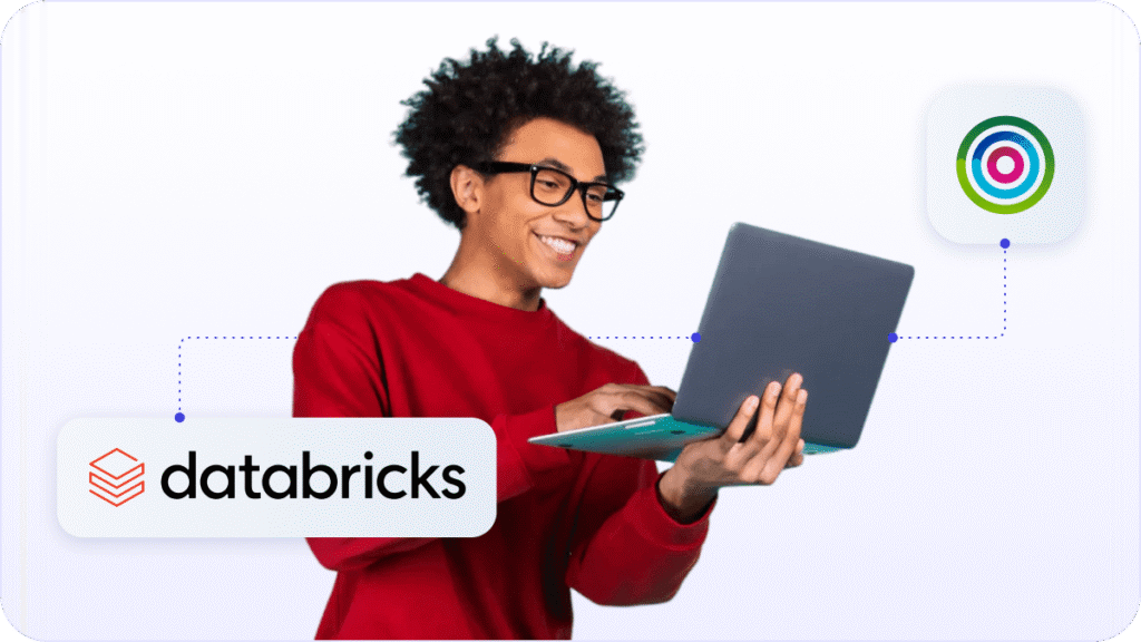 Marketer holding laptop with Databricks logo