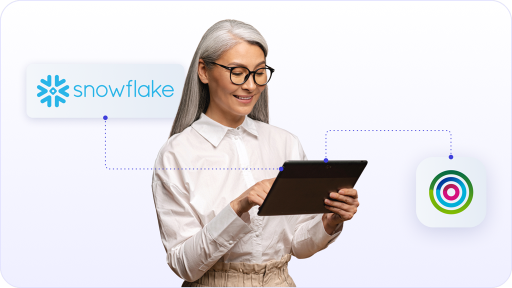 Marketer smiling at smart device with Snowflake logo