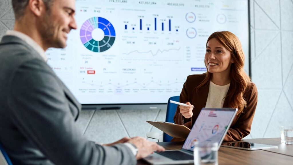 Marketers collaborating on analytics and data during meeting stock photo