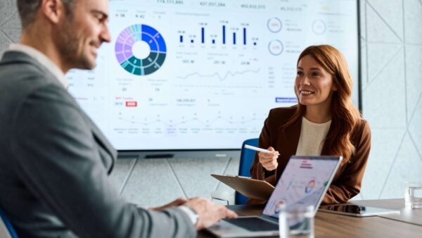 Marketers collaborating on analytics and data during meeting stock photo