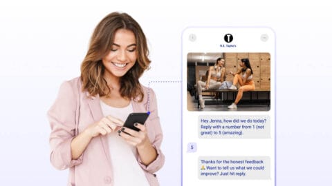 Women smiling at phone receiving two-way sms message