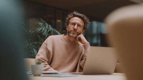 Marketer - Marketer wearing glasses in deep thought