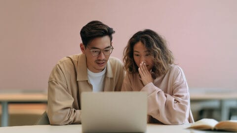 Two marketers looking shocked at laptop