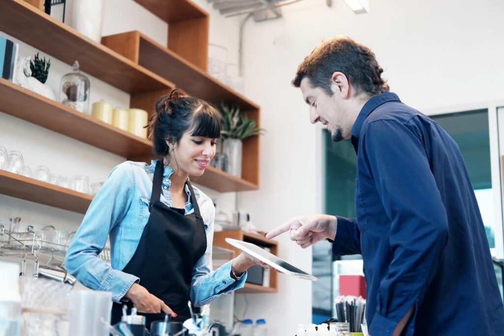 Cashier capturing a new subscribers email address in store