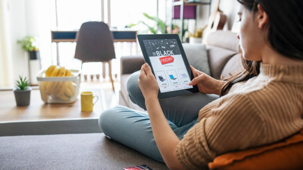 Woman browsing Black Friday sales on tablet